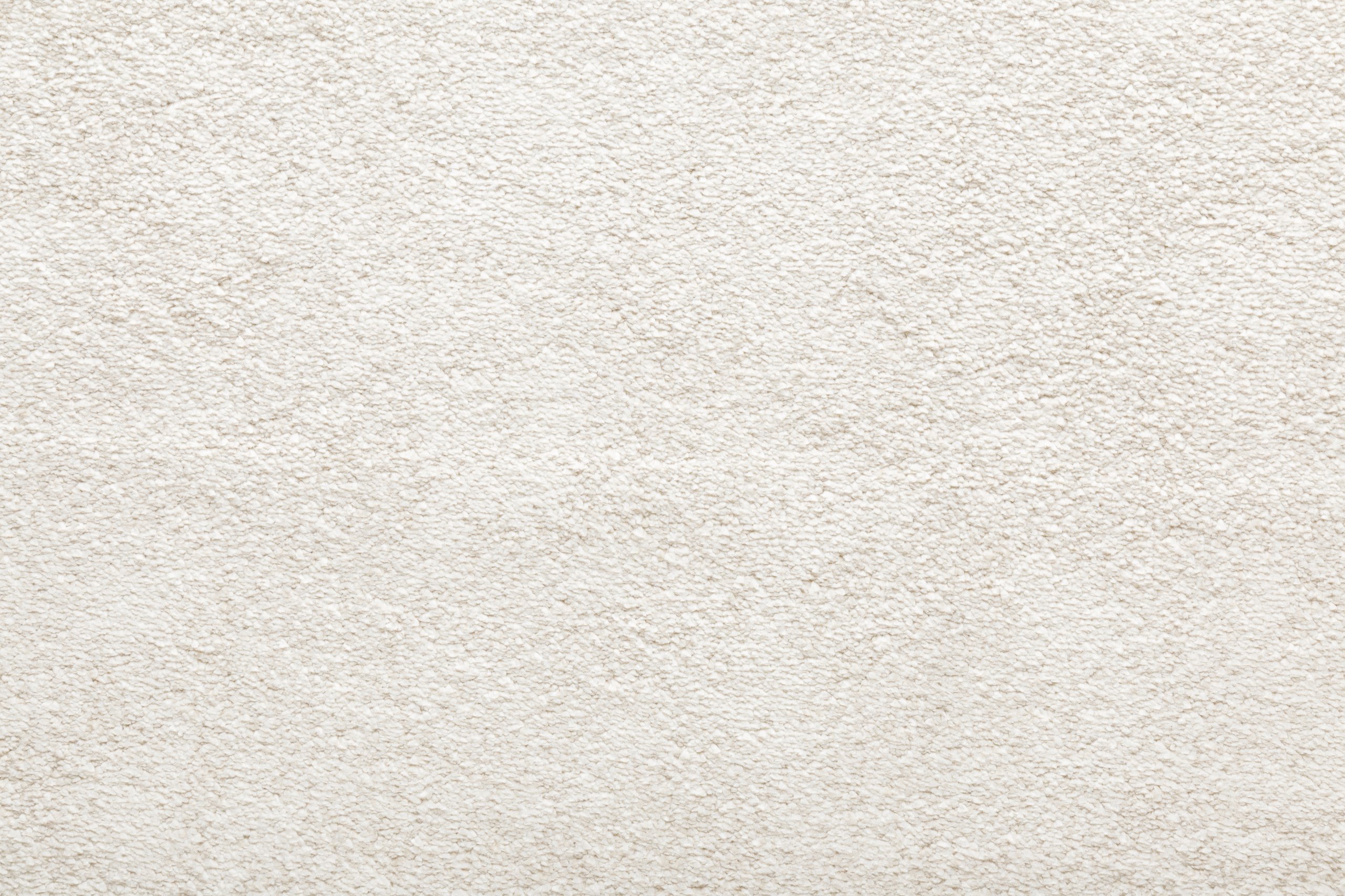 White new fluffy home carpet background. Closeup.